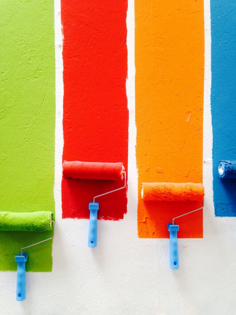 Colorful paint rollers refreshing a wall